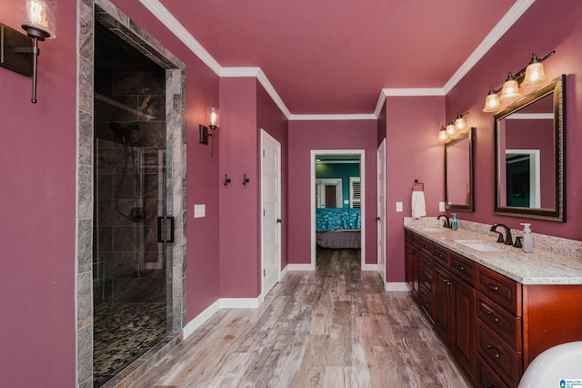 full bathroom with a sink, baseboards, ensuite bath, and wood finished floors