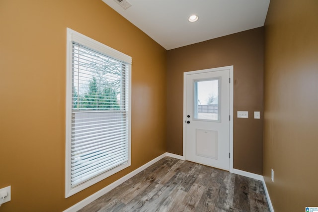 entryway with recessed lighting, visible vents, baseboards, and wood finished floors