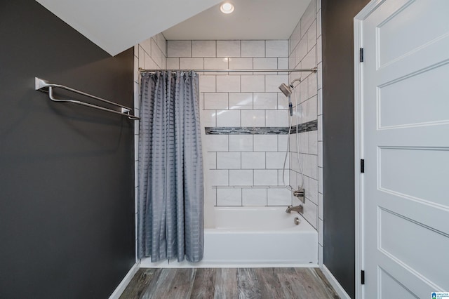 bathroom with shower / tub combo with curtain, baseboards, and wood finished floors