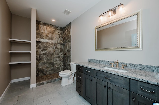 bathroom with visible vents, a walk in shower, baseboards, toilet, and vanity