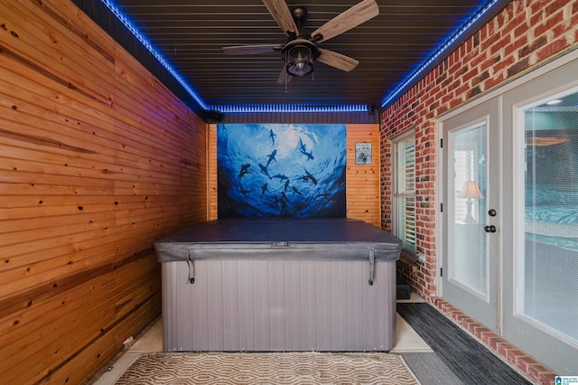 exterior space with ceiling fan and a hot tub