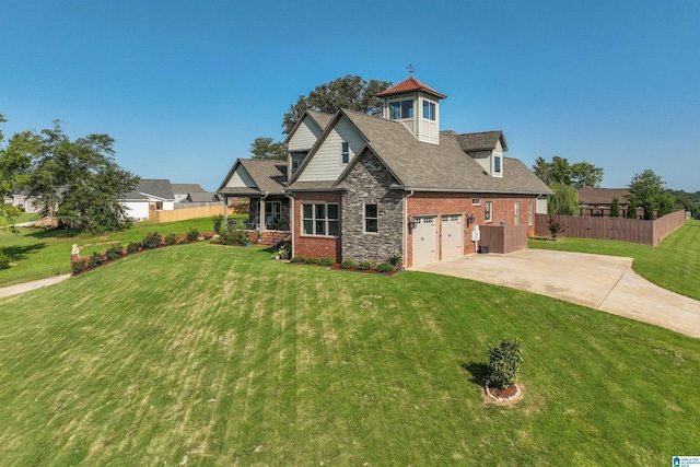 view of front facade featuring stone siding, concrete driveway, a front yard, and fence