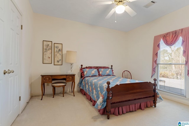 carpeted bedroom with visible vents and a ceiling fan