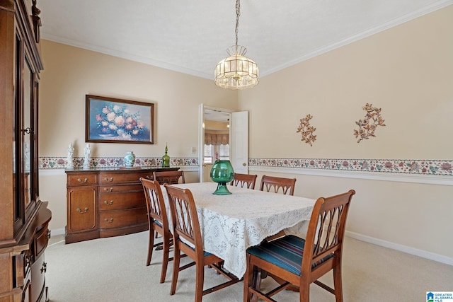 dining space featuring baseboards, light carpet, an inviting chandelier, and crown molding