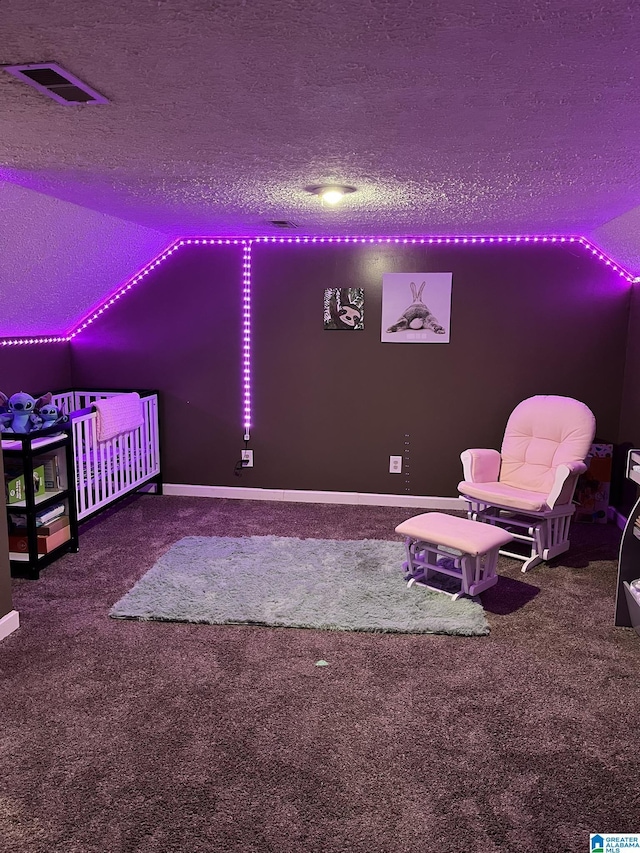 bedroom featuring visible vents, lofted ceiling, a textured ceiling, and carpet