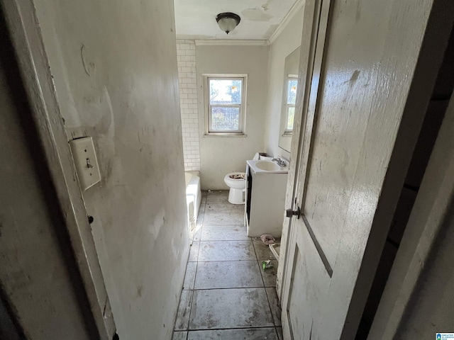 full bath featuring vanity, toilet, a tub, and ornamental molding