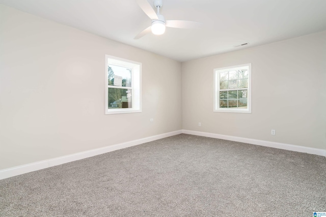 spare room with baseboards, carpet, and a ceiling fan