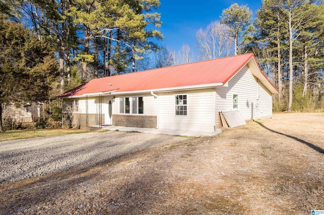 view of front of house with brick siding and metal roof