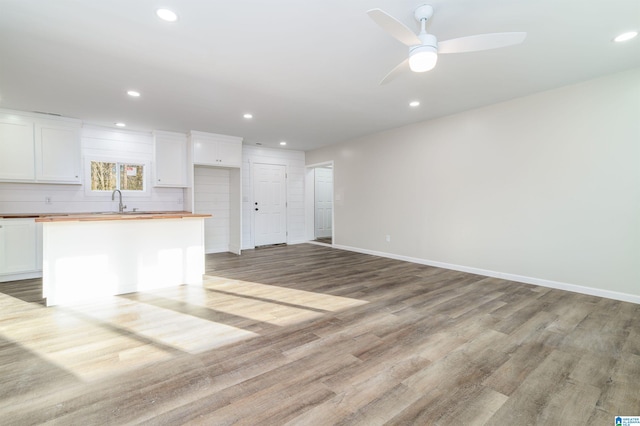 interior space featuring recessed lighting, light wood-style flooring, baseboards, and ceiling fan