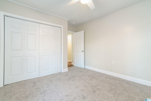 unfurnished bedroom featuring a closet, carpet flooring, ceiling fan, and baseboards