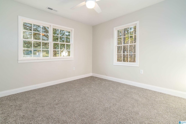 spare room featuring visible vents, baseboards, carpet, and ceiling fan