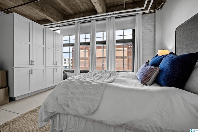bedroom featuring multiple windows and concrete flooring