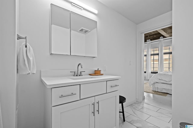 bathroom featuring visible vents, marble finish floor, and vanity