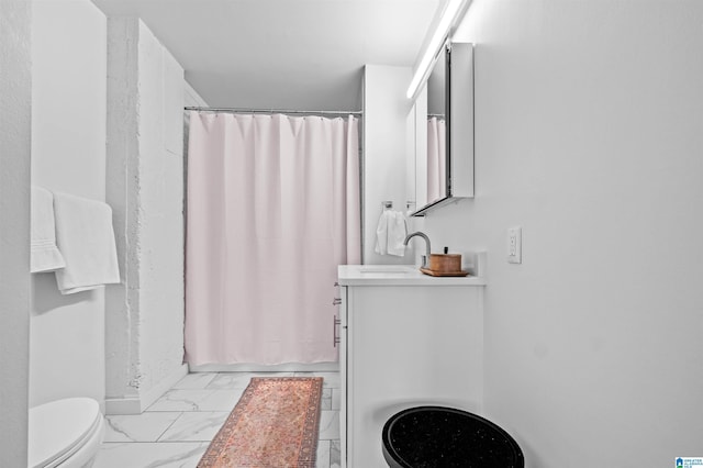 full bathroom with marble finish floor, curtained shower, toilet, and vanity