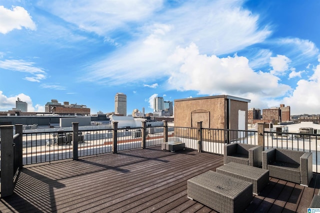 deck featuring a city view and outdoor lounge area