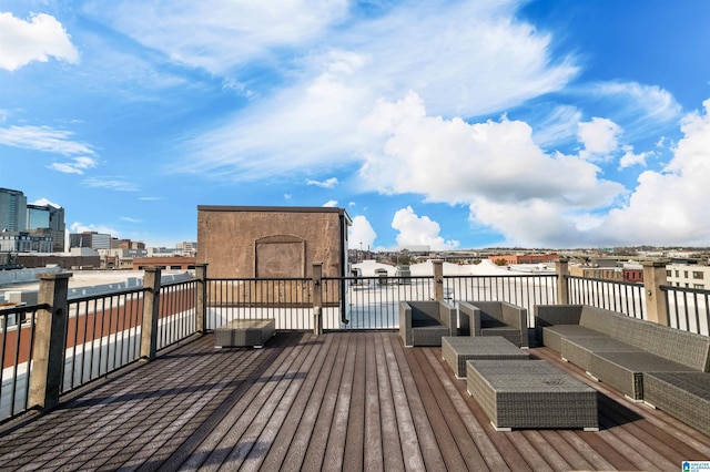 wooden terrace featuring an outdoor hangout area and a view of city