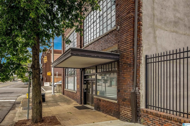 exterior space with brick siding and fence