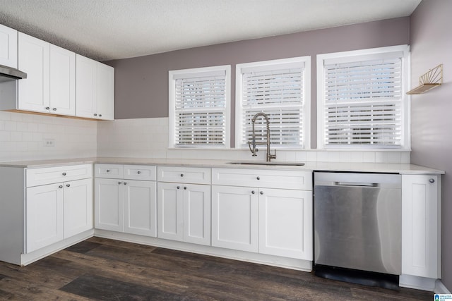 kitchen with dark wood-style flooring, a sink, light countertops, white cabinets, and dishwasher