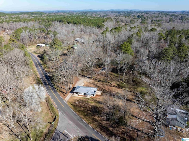 birds eye view of property featuring a wooded view