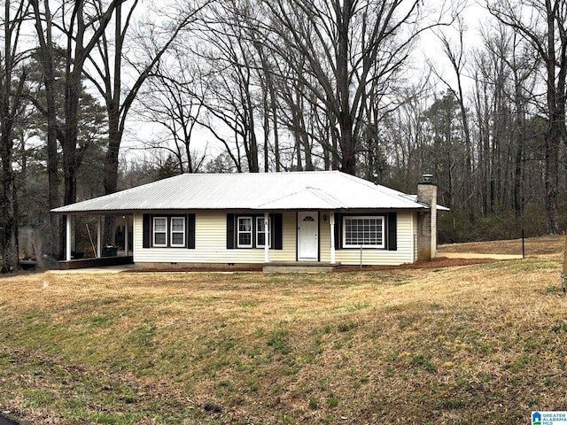 view of front facade featuring crawl space, a chimney, a front lawn, and metal roof