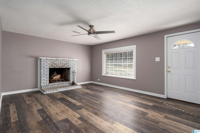 unfurnished living room with baseboards, wood finished floors, and a fireplace