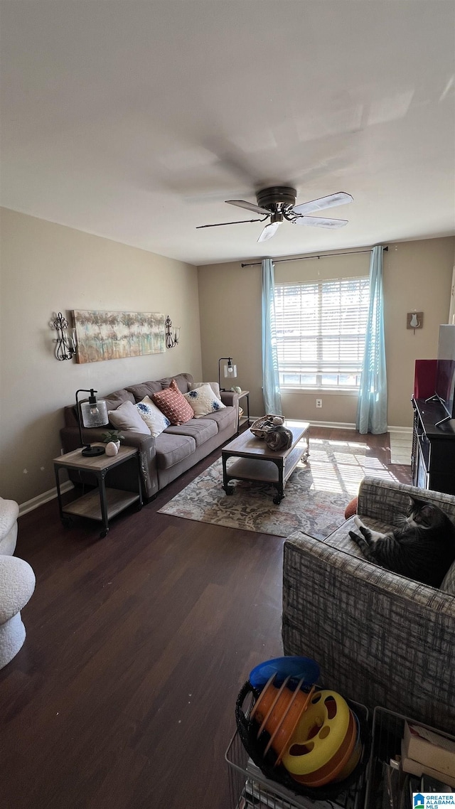 living room with baseboards, ceiling fan, and wood finished floors