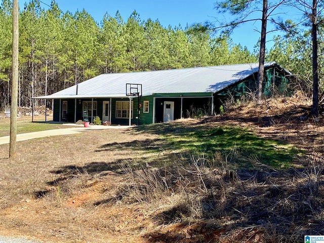 view of front of home with a porch and metal roof