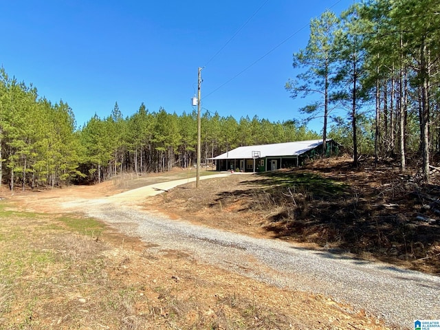 view of road featuring a wooded view