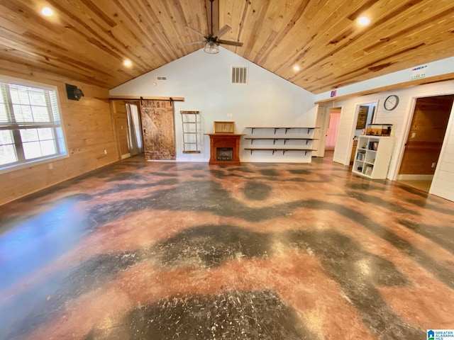 interior space with concrete floors, a barn door, wood ceiling, and visible vents