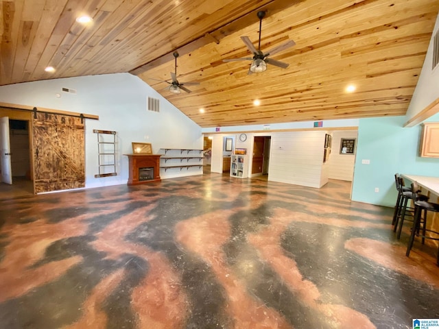 interior space featuring visible vents, wood ceiling, concrete floors, and a barn door