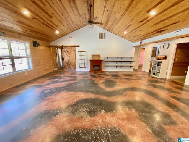 interior space featuring visible vents, wood ceiling, concrete flooring, and a barn door