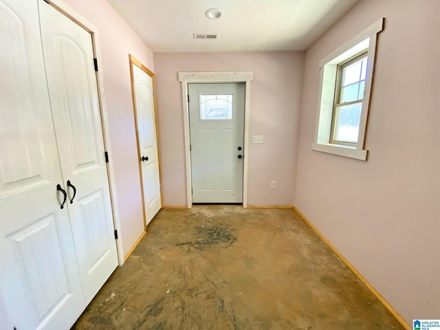 entryway featuring visible vents, baseboards, and concrete flooring