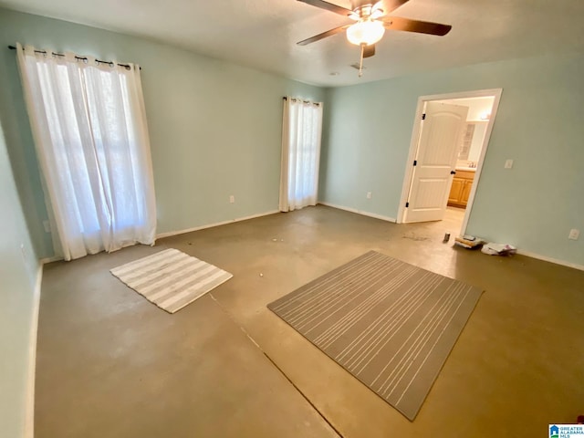 interior space with baseboards, plenty of natural light, and a ceiling fan