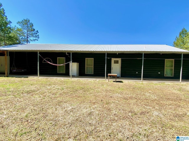 back of house featuring a carport