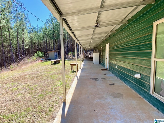 view of patio / terrace featuring a storage unit and an outdoor structure