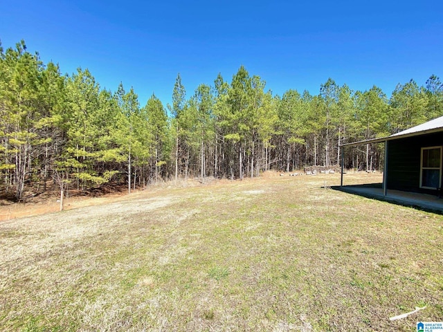 view of yard with a view of trees