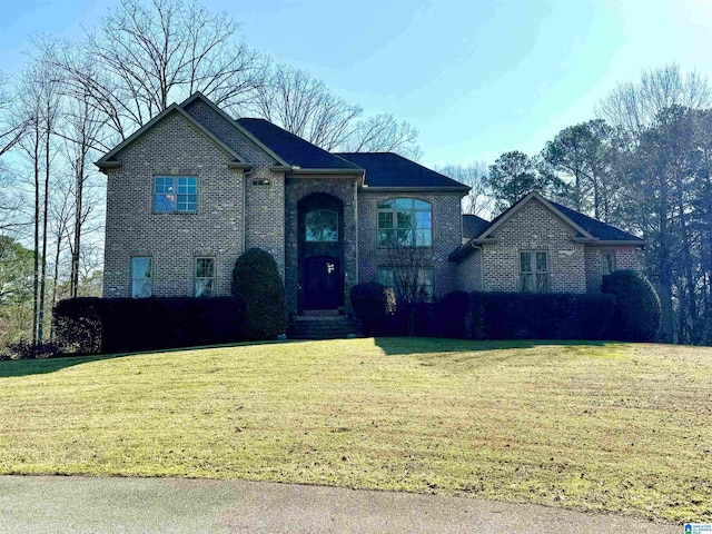 view of front of property with brick siding and a front lawn