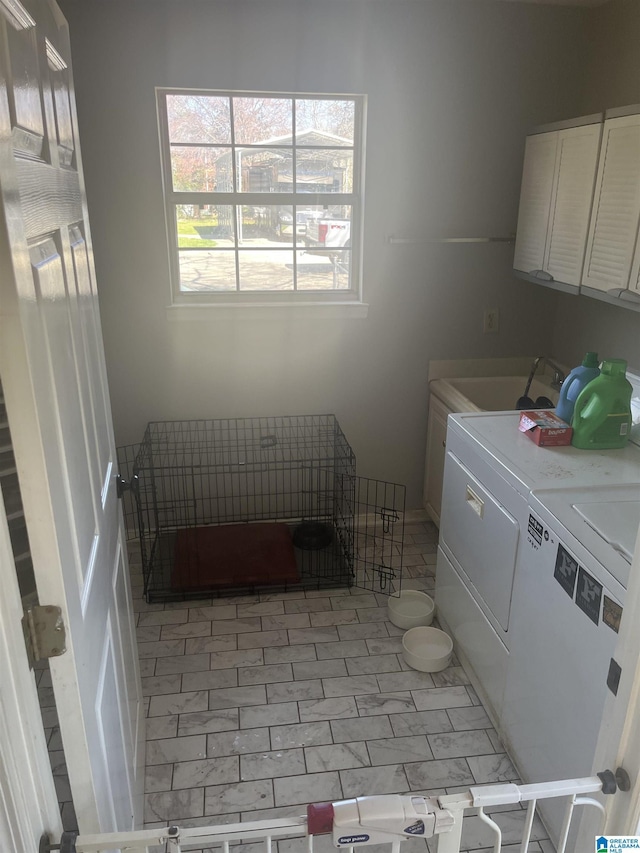 laundry room featuring a sink, cabinet space, and washing machine and dryer