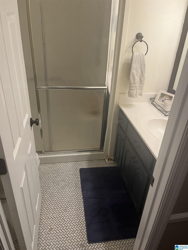 full bath with vanity, tile patterned floors, and a stall shower