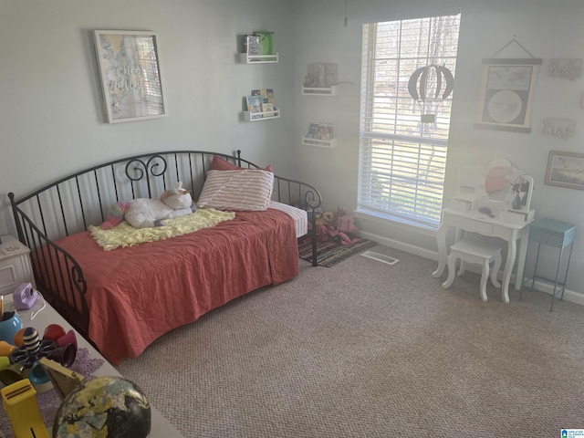 carpeted bedroom with baseboards and visible vents