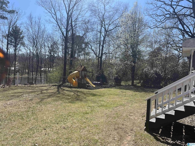 view of yard with a playground and fence