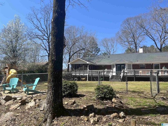 exterior space with a wooden deck, a yard, and fence