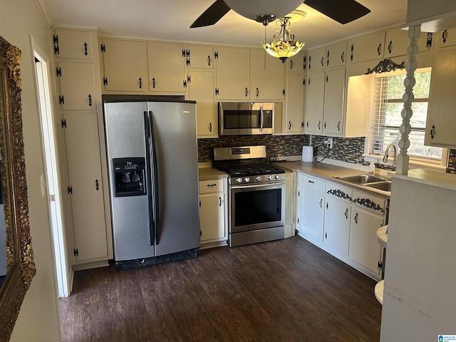 kitchen with a sink, dark wood-type flooring, backsplash, and stainless steel appliances