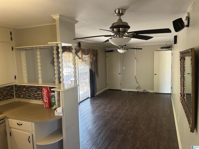 interior space with crown molding, dark wood-type flooring, ceiling fan, light countertops, and white cabinetry