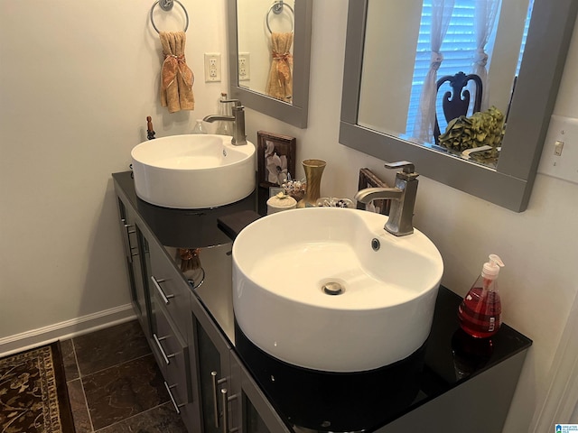 bathroom with vanity and baseboards