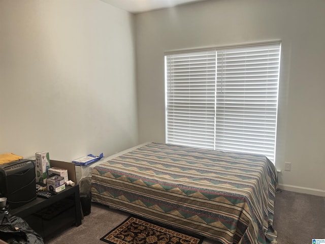 bedroom with baseboards and carpet floors