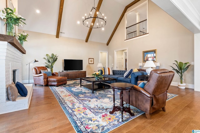 living room featuring beam ceiling, a notable chandelier, wood finished floors, and high vaulted ceiling