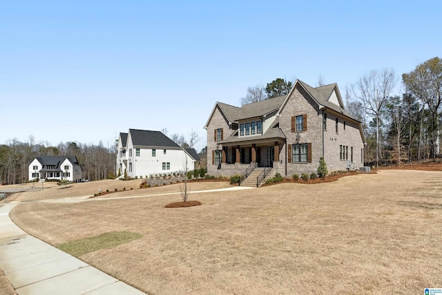 view of front of house featuring a front yard and central air condition unit