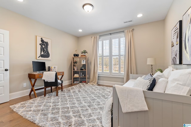 office space with recessed lighting, wood finished floors, visible vents, and baseboards