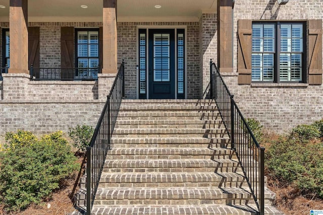 doorway to property featuring brick siding